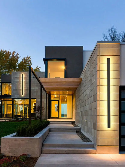 Modern minimalist house with decorbites black waterproof led wall light featuring sleek stone and wood exterior accents
