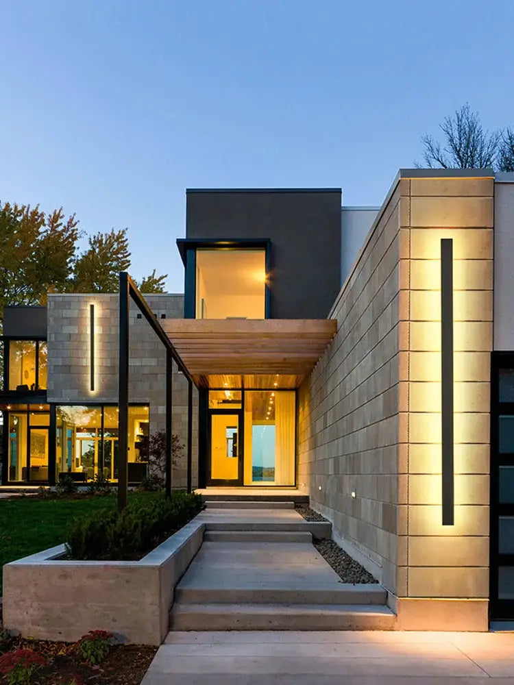 Modern minimalist house with decorbites black waterproof led wall light featuring sleek stone and wood exterior accents
