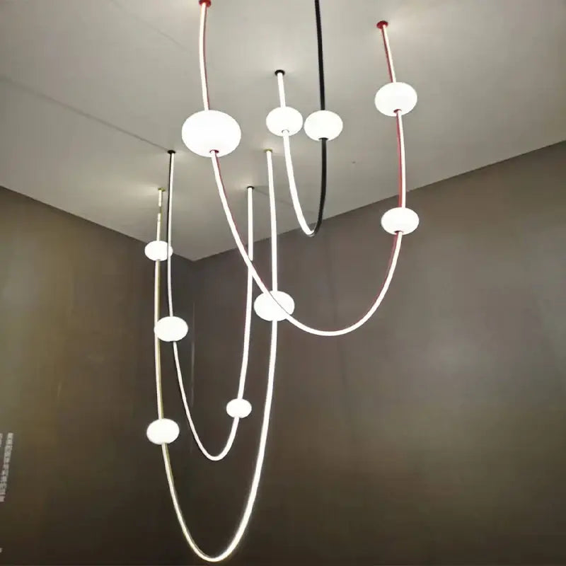 Modern minimalist ceiling chandelier with curved black and white cables and frosted glass decorbites colorized led dimmable lights