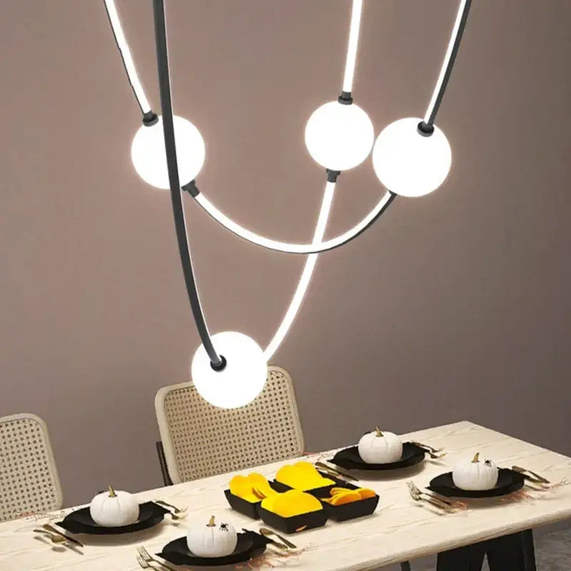 Modern black-framed ceiling chandelier with glowing white spherical bulbs decorbites colorized led dimmable lighting