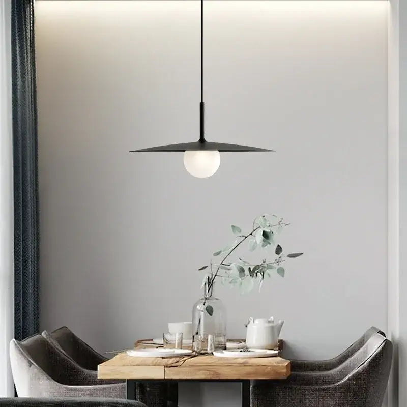 Modern minimalist black decorbites flying saucer pendant light with disc-shaped iron shade and frosted glass globe bulb