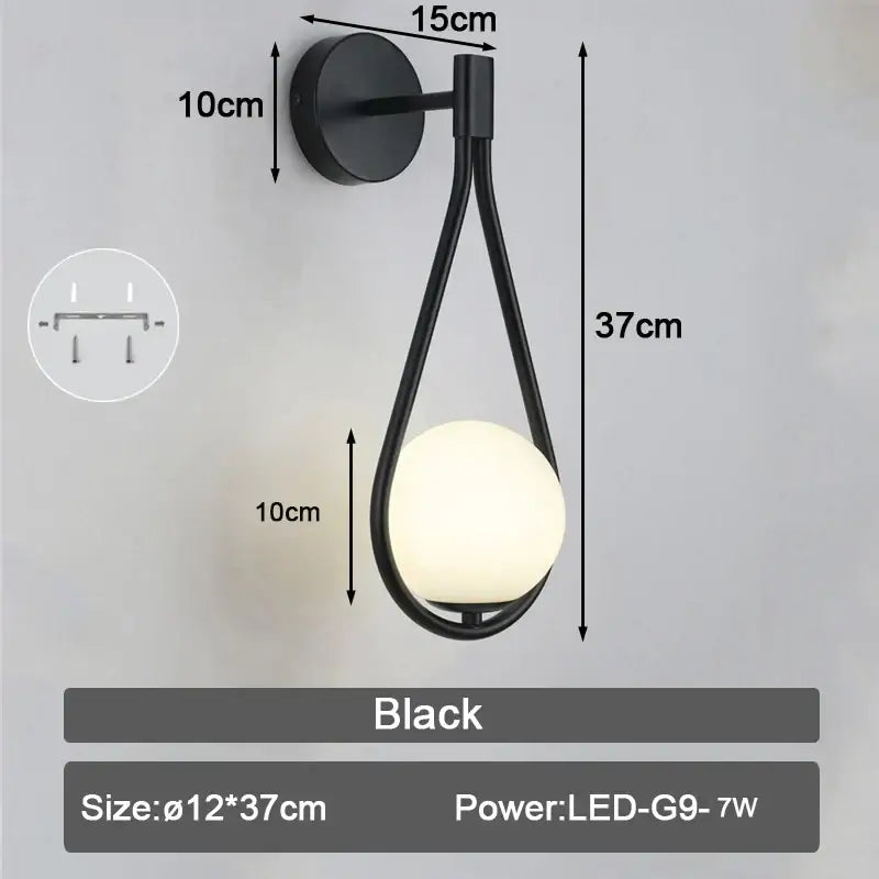 Black modern wall lamp with sleek curved metal frame and illuminated frosted glass ball led wall lamp for bedroom