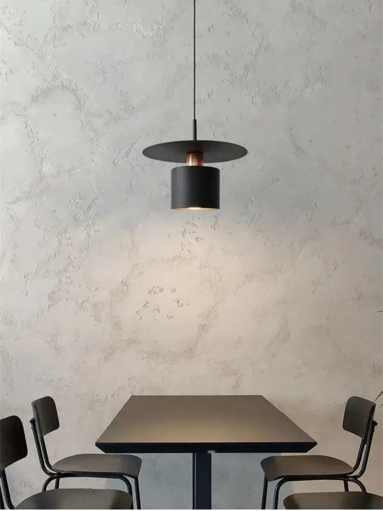 Modern minimalist black pendant lights with cylindrical shade and copper accent for elegant led pendant kitchen lighting