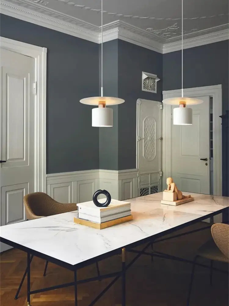 Two elegant led pendant lights with white cylindrical shades and copper fixtures for modern kitchen lighting