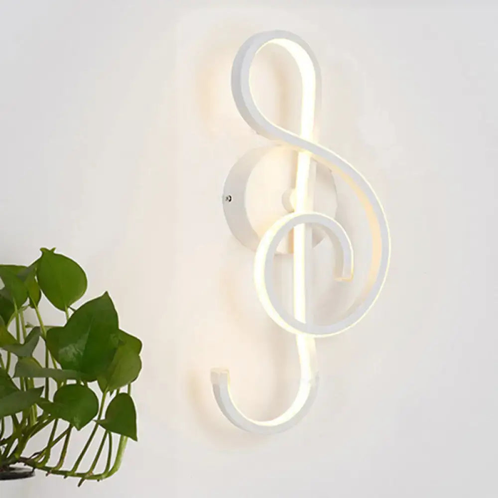 White led wall sconce shaped like a musical treble clef in modern minimalist black white design for bedroom lighting