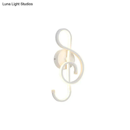 White led wall sconce shaped like a musical treble clef in modern minimalist black white bedroom wall light design