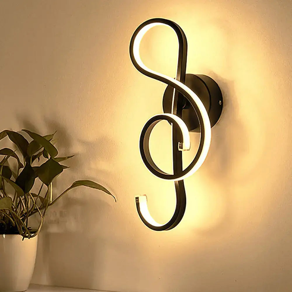 Modern minimalist black and white led ring sconce shaped like a treble clef with illuminated curved lines for bedroom walls