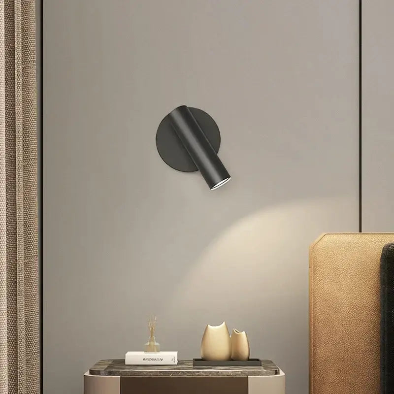 Modern minimalist black cylindrical led wall lamp with matte finish and adjustable head for bedroom spotlight use