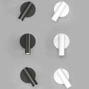 Modern minimalist black and white led wall lamp featuring cylindrical fixtures and circular backplates for bedroom lighting