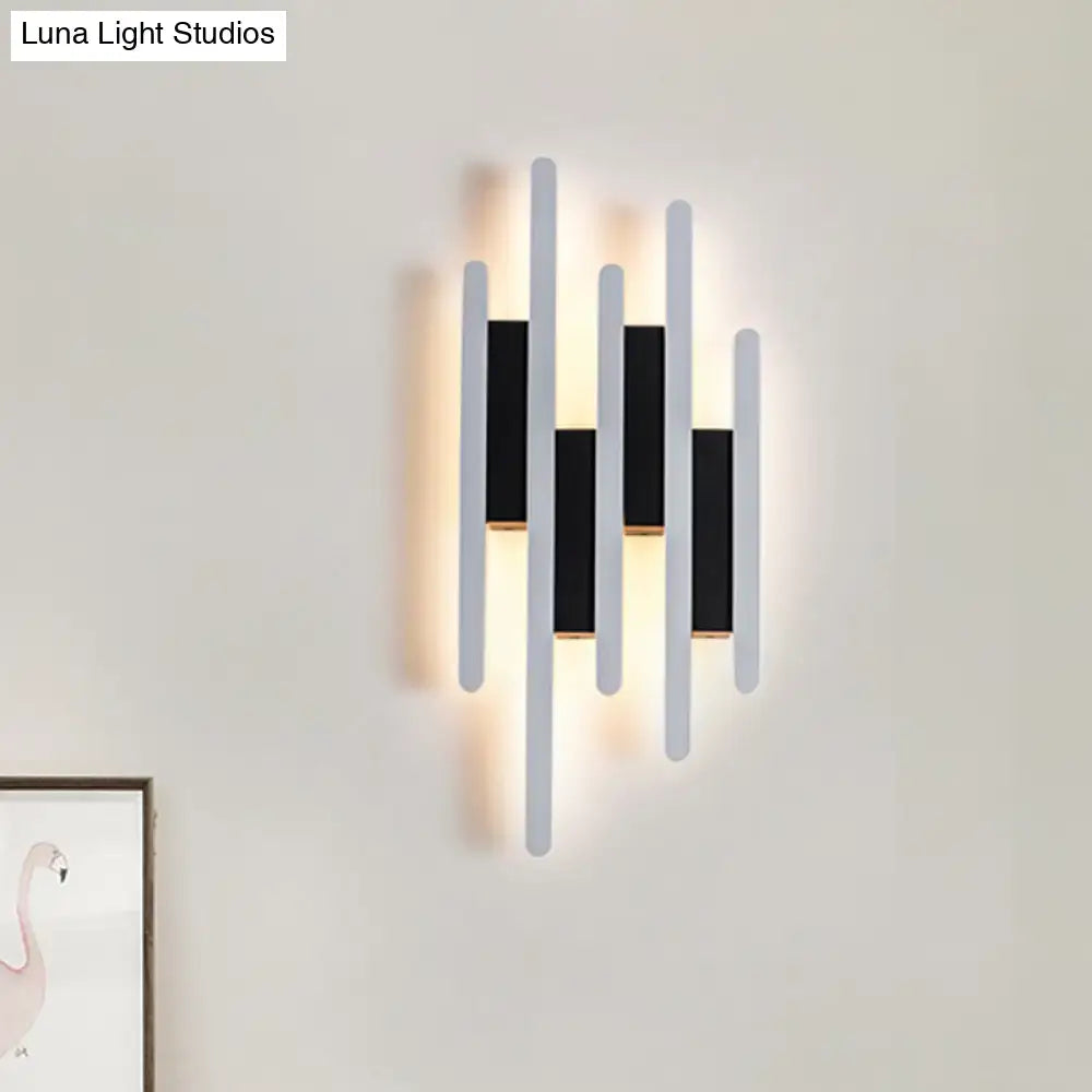 Modern minimalist black and white led wall sconce with five vertical bars providing warm white light for bedroom use