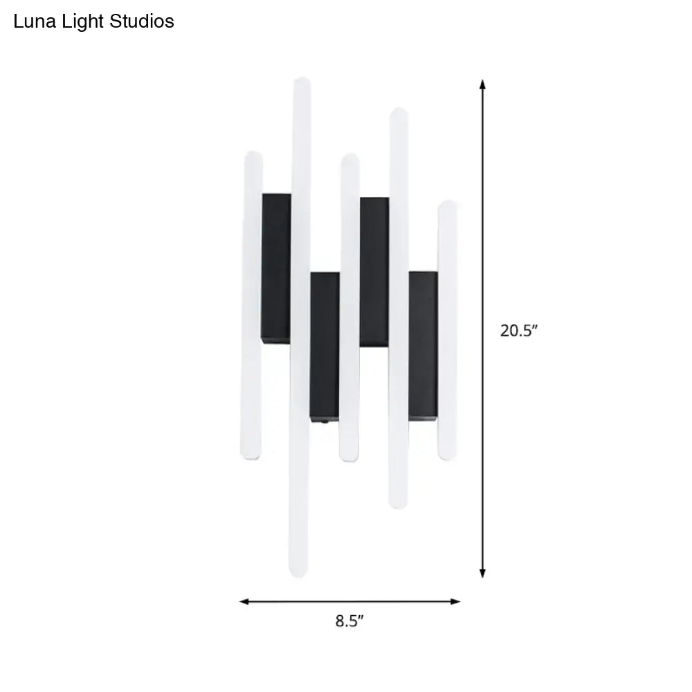 Modern minimalist black and white led wall sconce with a sleek rectangular design emitting warm white light for bedrooms