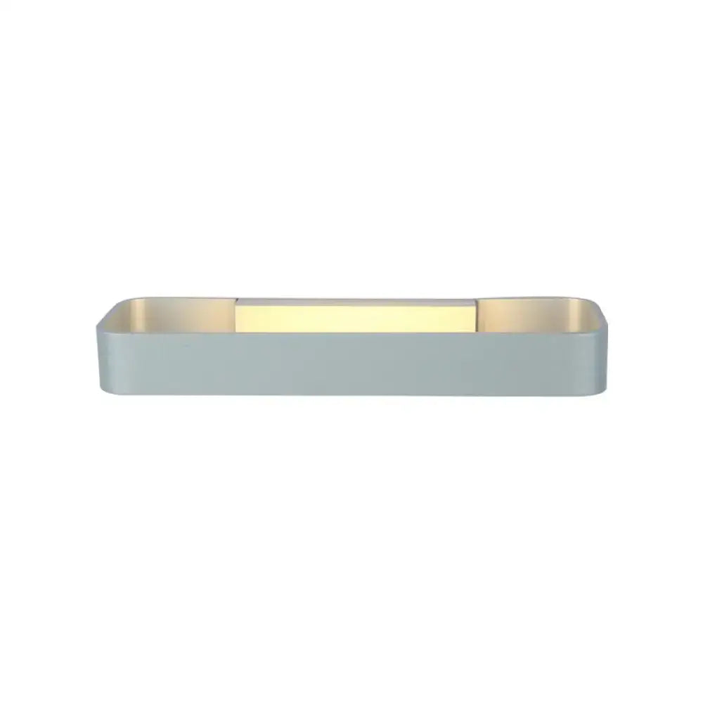 Modern minimalist black and white rectangular wall lamp with matte gray exterior and warm gold interior lighting for bedroom