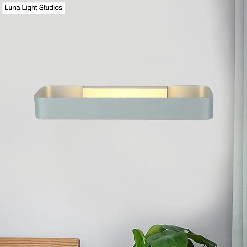 Modern minimalist wall lamp with rectangular matte light gray finish and warm gold interior perfect for bedroom lighting