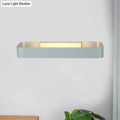 Modern minimalist wall lamp with rectangular matte light gray finish and warm gold interior perfect for bedroom lighting