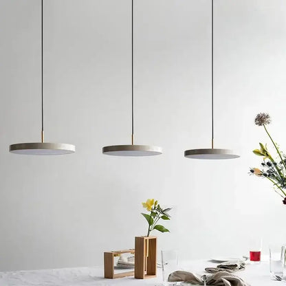 Three minimalist pendant lights with gray concrete shades and black cords for modern decorbites led study disc use