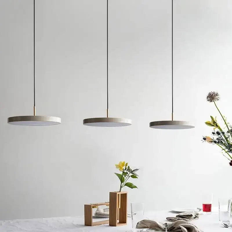 Three minimalist pendant lights with gray concrete shades and black cords for modern decorbites led study disc use