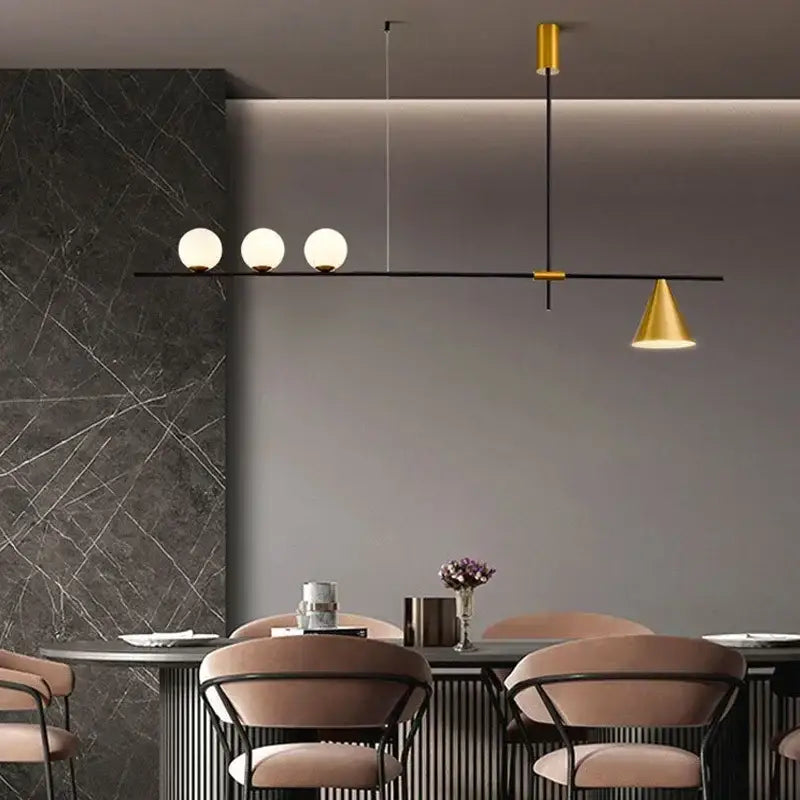 Modern minimalist brass and glass chandelier pendant light with frosted glass bulbs and gold-toned shade for dining room