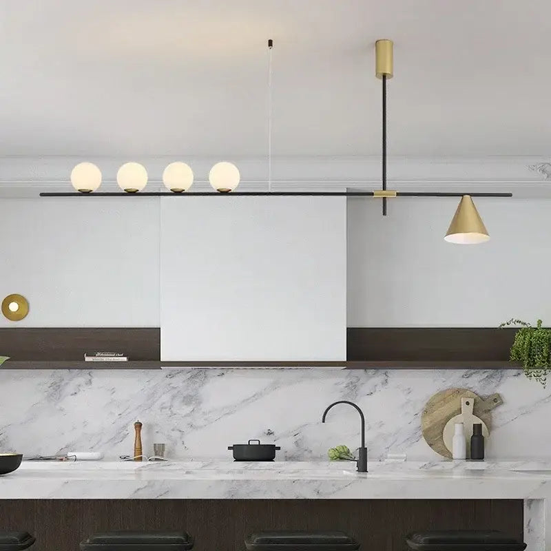 Modern minimalist brass and glass chandelier pendant light with four frosted glass bulbs and gold-toned shade for dining room