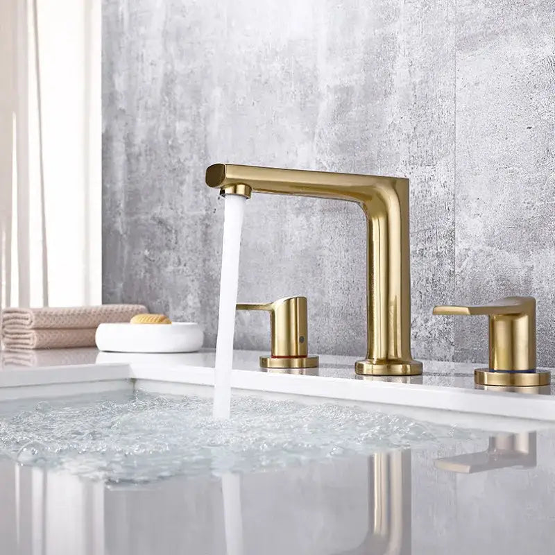 Modern minimalist brush gold widespread basin faucet with sleek three-handle design for bathroom decorbites brush gold