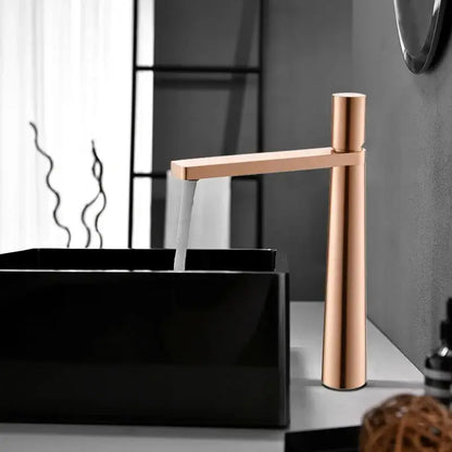 Modern minimalist brushed gold basin faucet with sleek rose gold finish and tall cylindrical spout decorbites brushed gold
