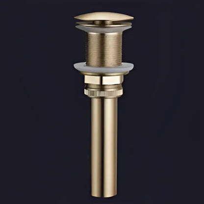 Modern minimalist gold brass basin drain stopper with textured ribbed body and smooth domed top decorbites brushed gold