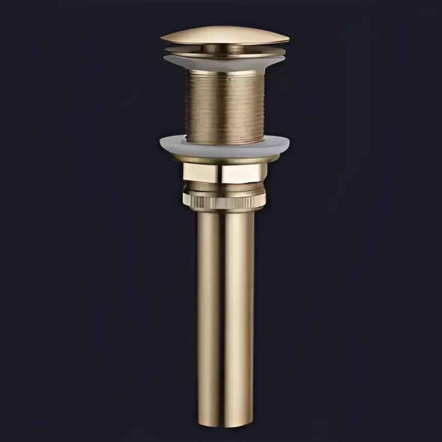 Modern minimalist gold brass basin drain stopper with textured ribbed body and smooth domed top decorbites brushed gold