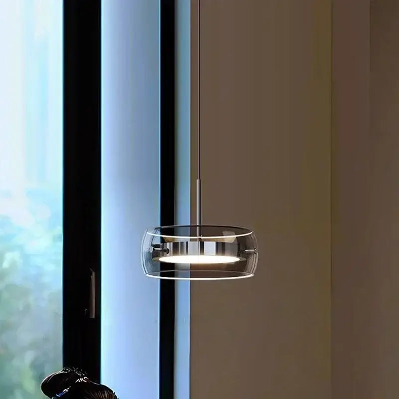 Modern minimalist chrome and glass dining pendant light featuring a sleek transparent glass ring and polished chrome accents