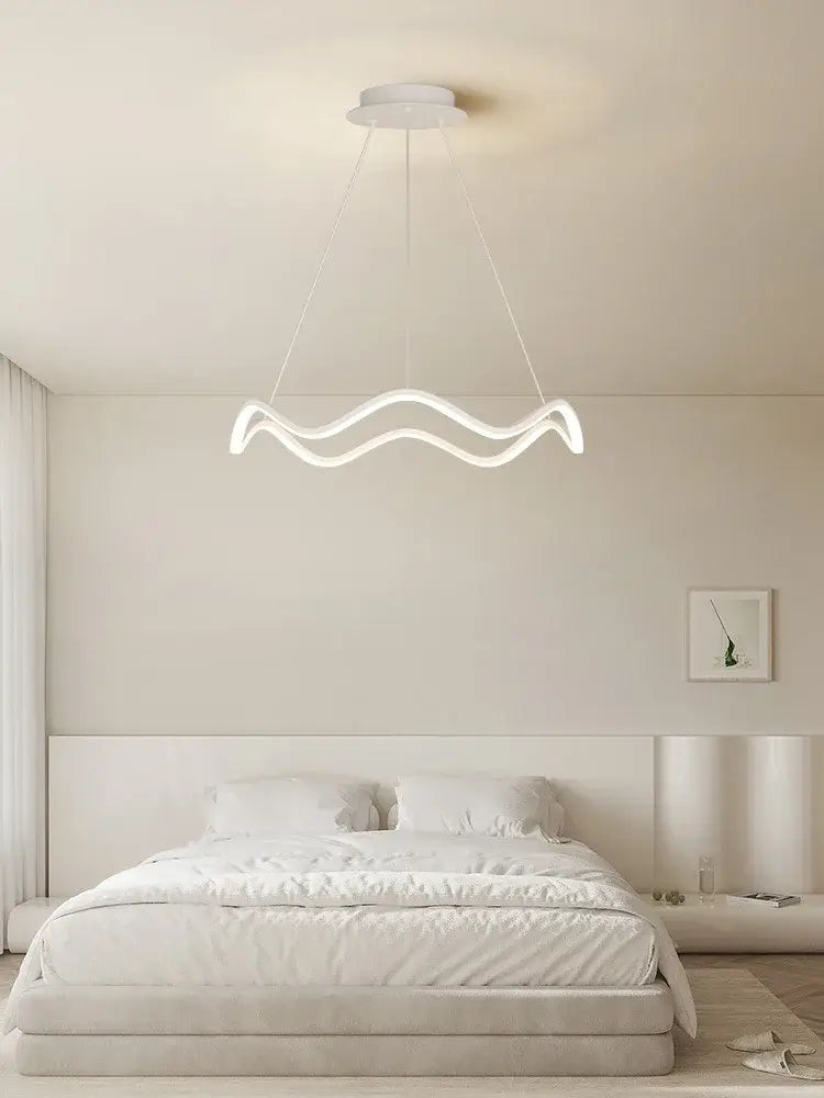 A modern white decorbites circle wave led pendant chandelier with sleek wavy design for dining room decor