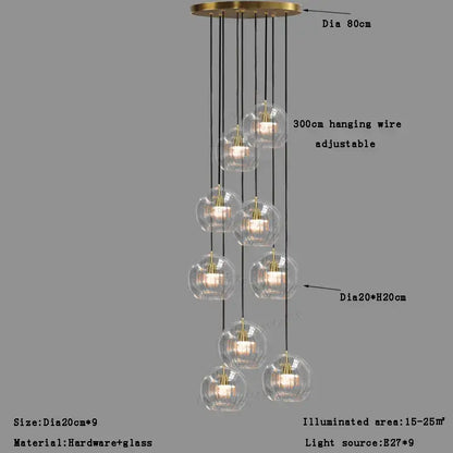 Modern minimalist clear glass ball pendant light with nine brass-finished globes and black cords for dining room decorbites