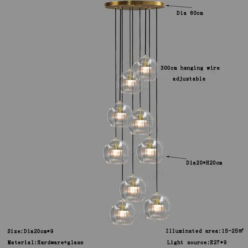 Modern minimalist clear glass ball pendant light with nine brass-finished globes and black cords for dining room decorbites