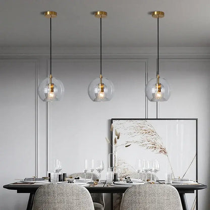 Three clear glass ball pendant lights with gold fixtures and black cords for dining room decorbites clear glass pendant light