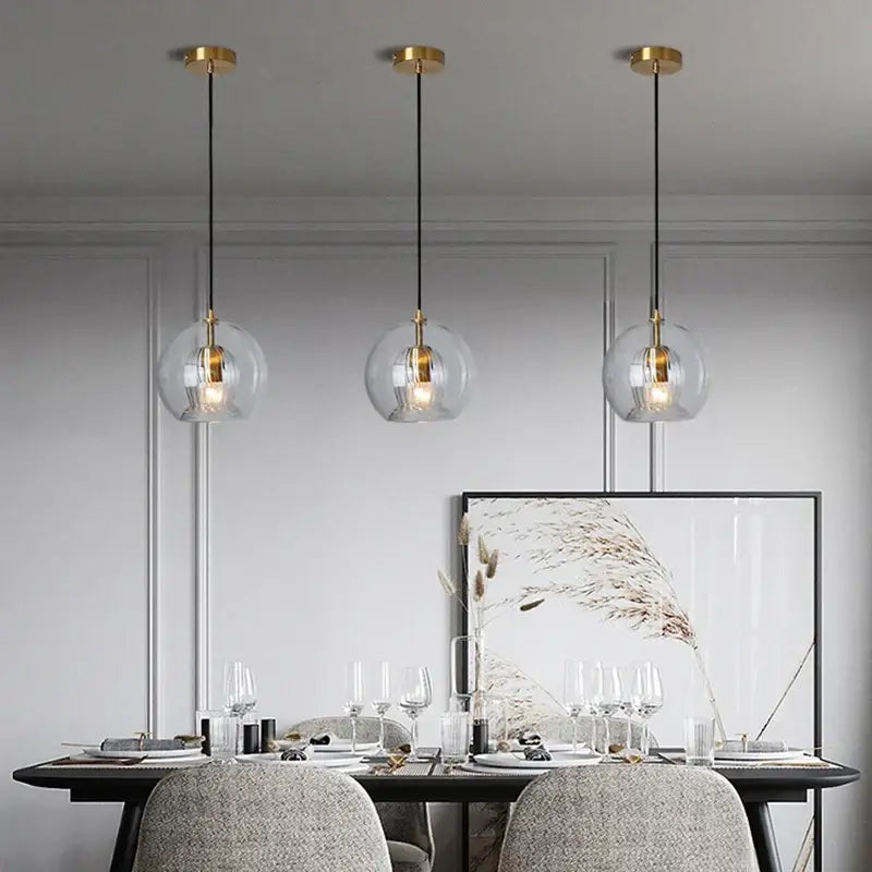 Three clear glass ball pendant lights with gold fixtures and black cords for dining room decorbites clear glass pendant light