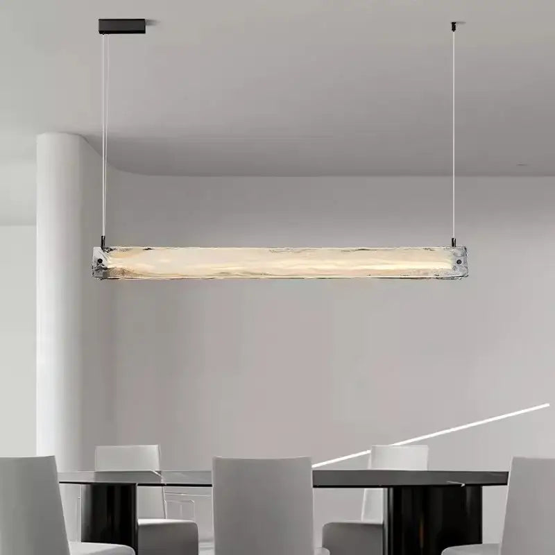 Modern minimalist pendant light with translucent textured cloud fog glass and black metal fixtures for dining room