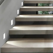 Modern minimalist concrete staircase with clean floating steps illuminated by led underground lamp lighting