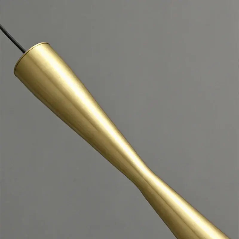 Golden brass pendant light with sleek tapered design and polished finish for modern minimalist dining room decorbites copper black gold