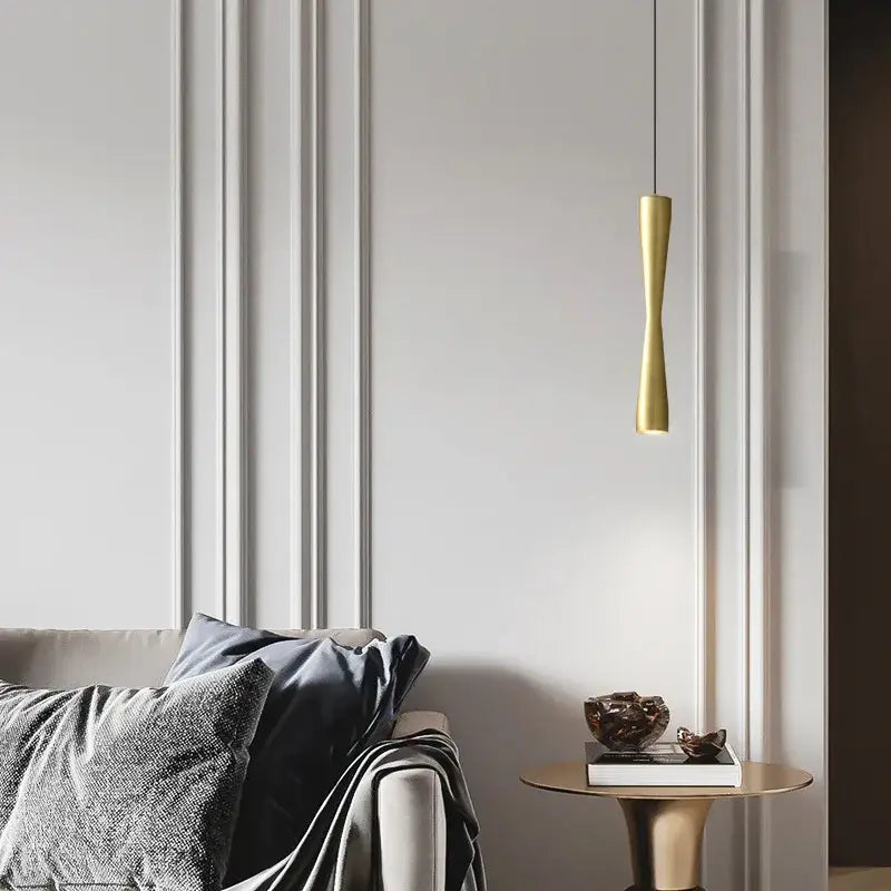 A sleek gold-toned copper black gold pendant light with an elongated cylindrical shape for modern dining room decorbites