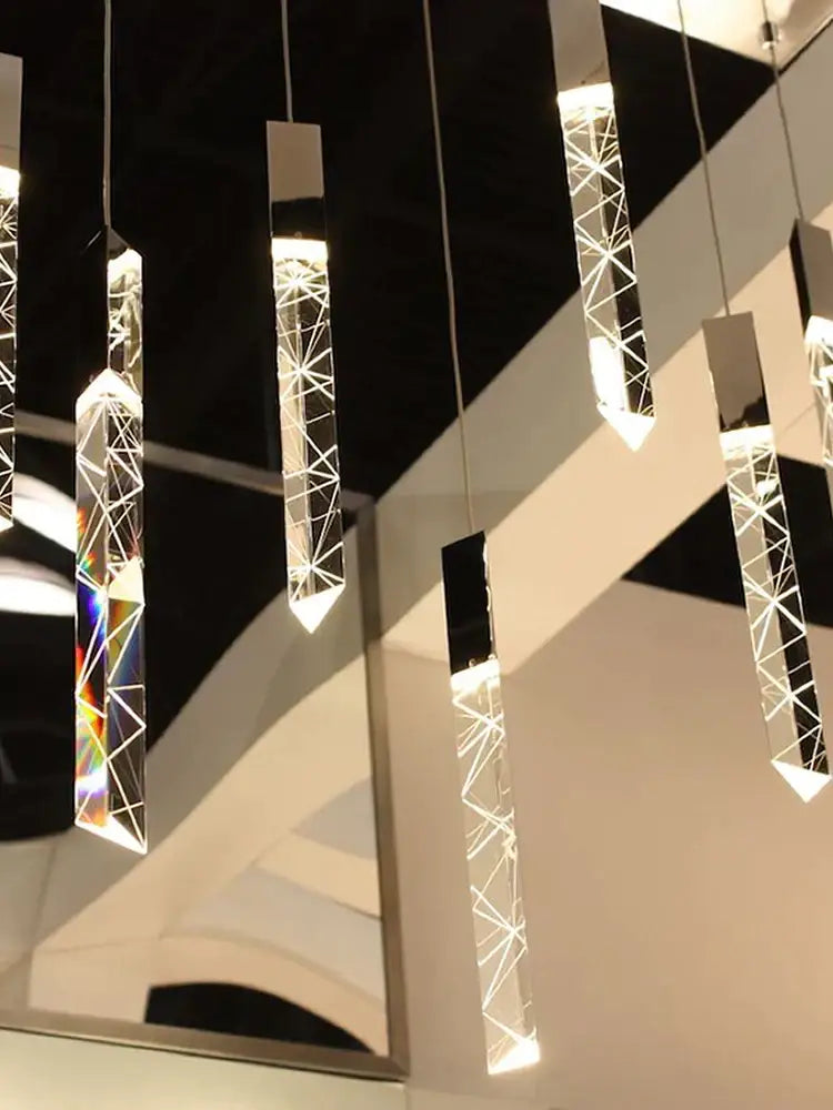 Modern minimalist crystal chrome led chandelier stairwell pendant light with geometric prismatic facets and illuminated internal structure decorbites crystal chrome