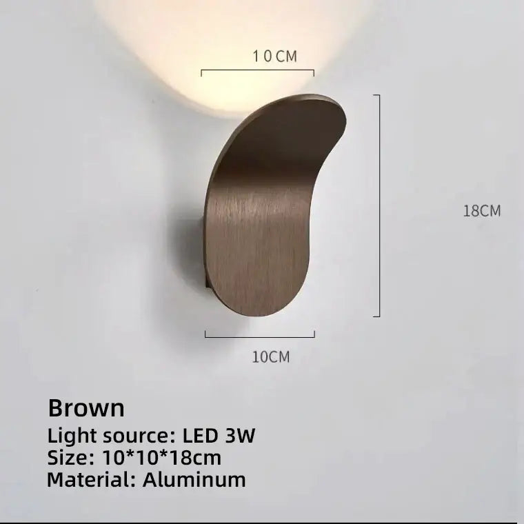 Brown aluminum led wall lamp with sleek curved design and 3w light source for modern minimalist living room use