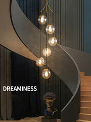 A modern curved staircase with sleek metallic finish and dark vertical paneling featuring decorbites glass ball chandelier light