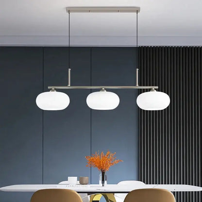 Modern minimalist decorbites glass chandelier with three frosted glass globes suspended by slender metal rods for living room