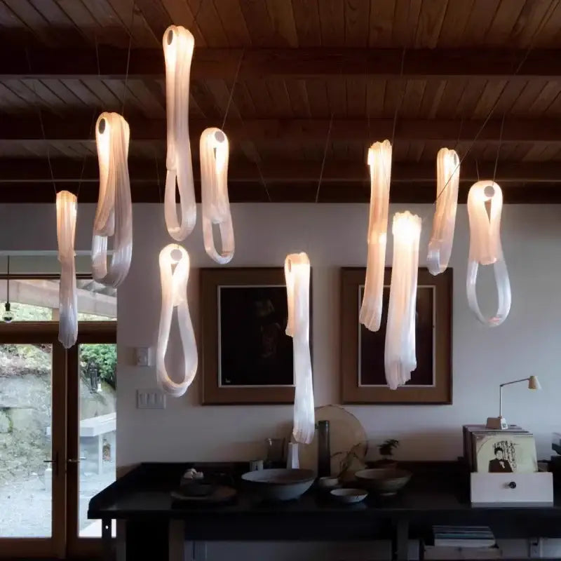 Elegant led glass chandelier with translucent ribbon-like pendants in minimalist design for dining room lighting