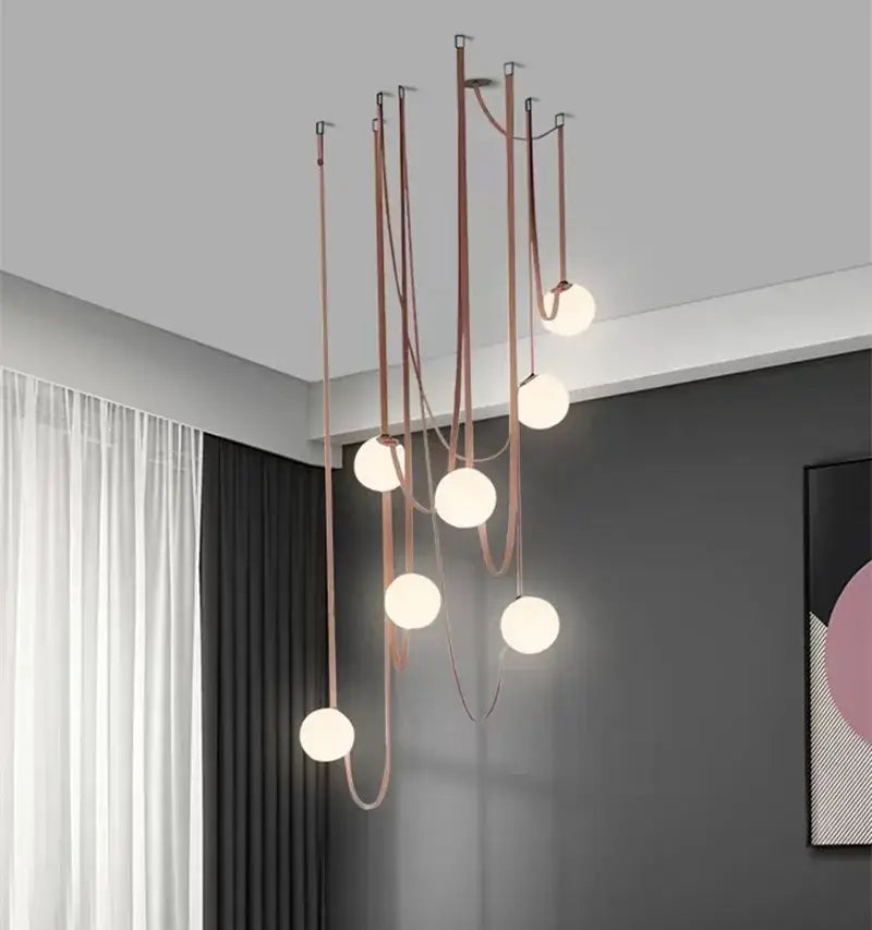 Modern minimalist pendant light with copper-toned metal rods and frosted glass ball bulbs for dining room decorbites glass ball