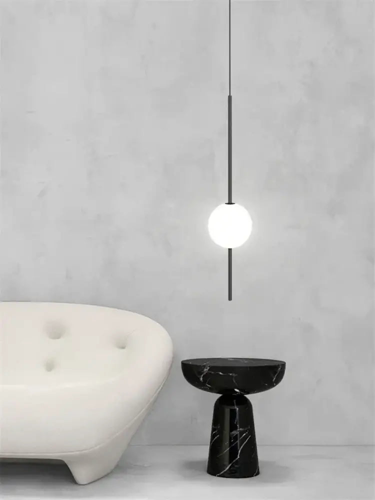 Black marble side table with sleek modern design and glossy finish complements decorbites glass ball led chandelier
