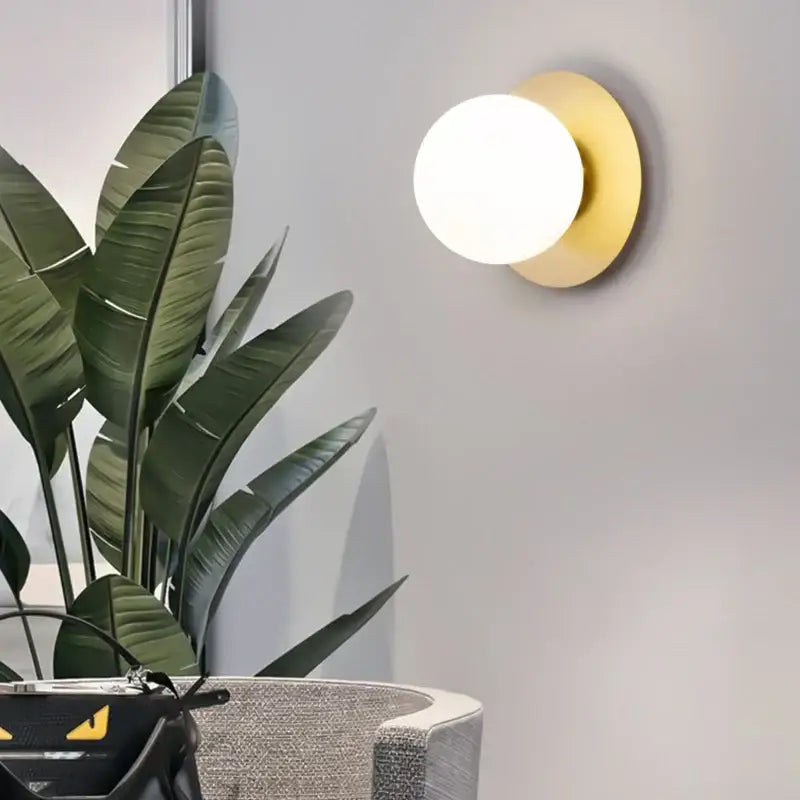 Gold-toned circular wall lamp with frosted glass globe modern minimalist led wall lamp for bedroom sconce lighting