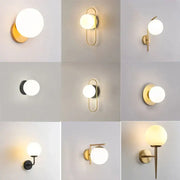 Modern minimalist glass ball led wall lamp with spherical frosted glass and metal frame in gold black or brass finishes