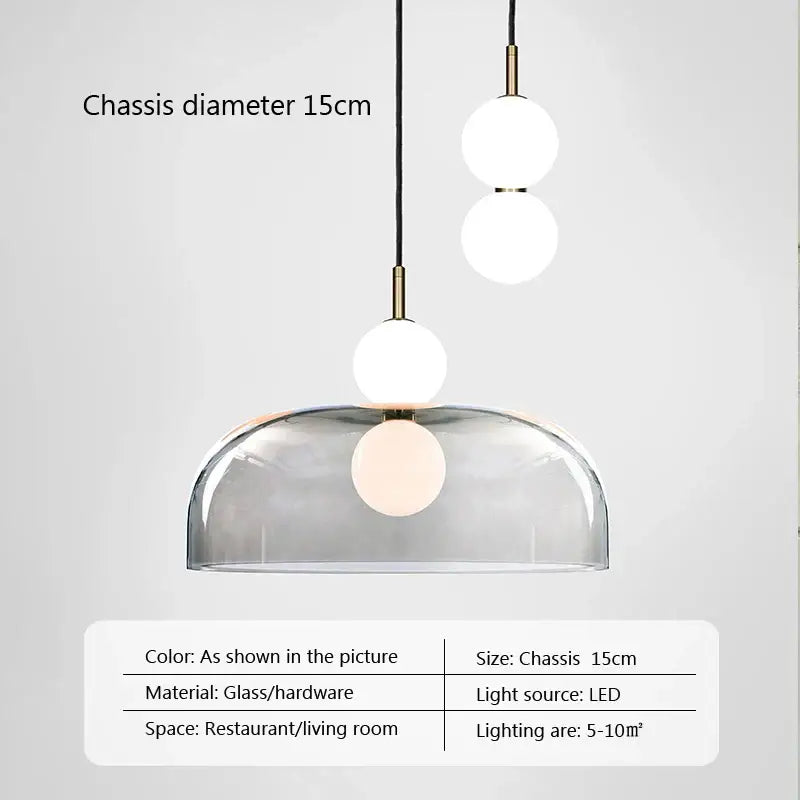 Modern minimalist pendant light with clear glass dome and three white led bulbs suspended by brass decorbites glass ball hardware
