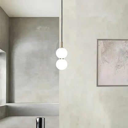 Modern minimalist pendant light with two frosted glass ball spheres and brass decorbites glass ball hardware for living room