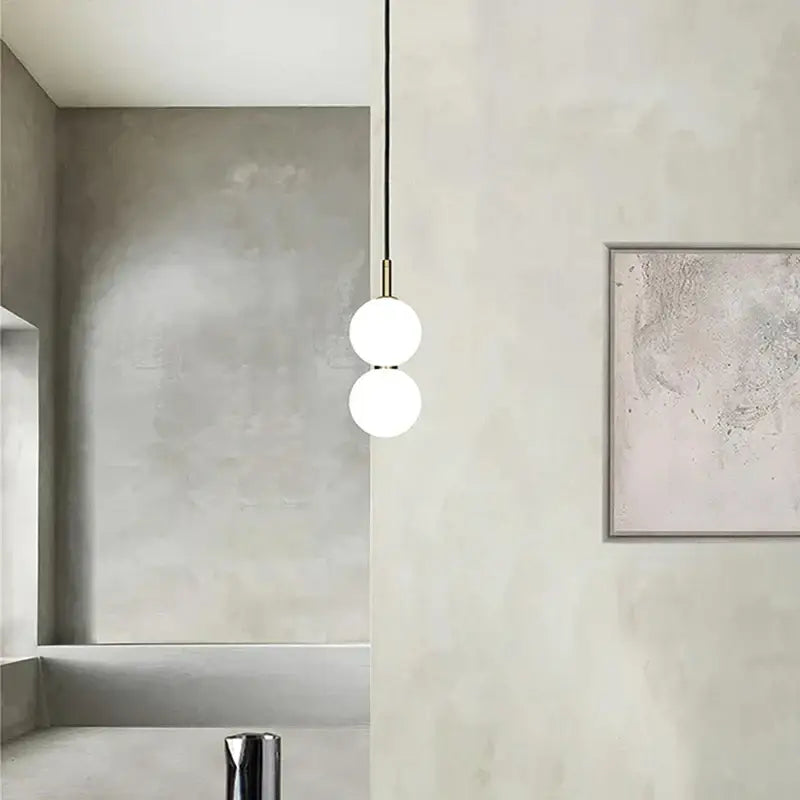 Modern minimalist pendant light with two frosted glass ball spheres and brass decorbites glass ball pendant hardware
