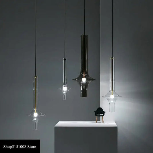 Modern minimalist glass pendant light with sleek metal finishes and flared base for kitchen hanging lamp use