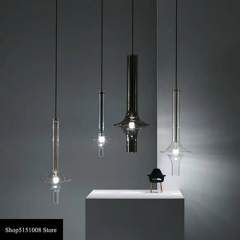 Modern minimalist glass pendant light with sleek metal finishes and flared base for kitchen hanging lamp use